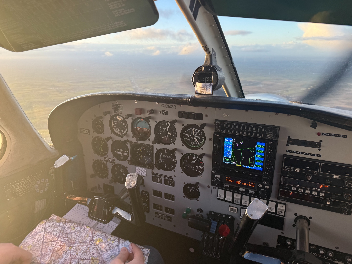 Cockpit with student perspective and flight log during in-air instruction