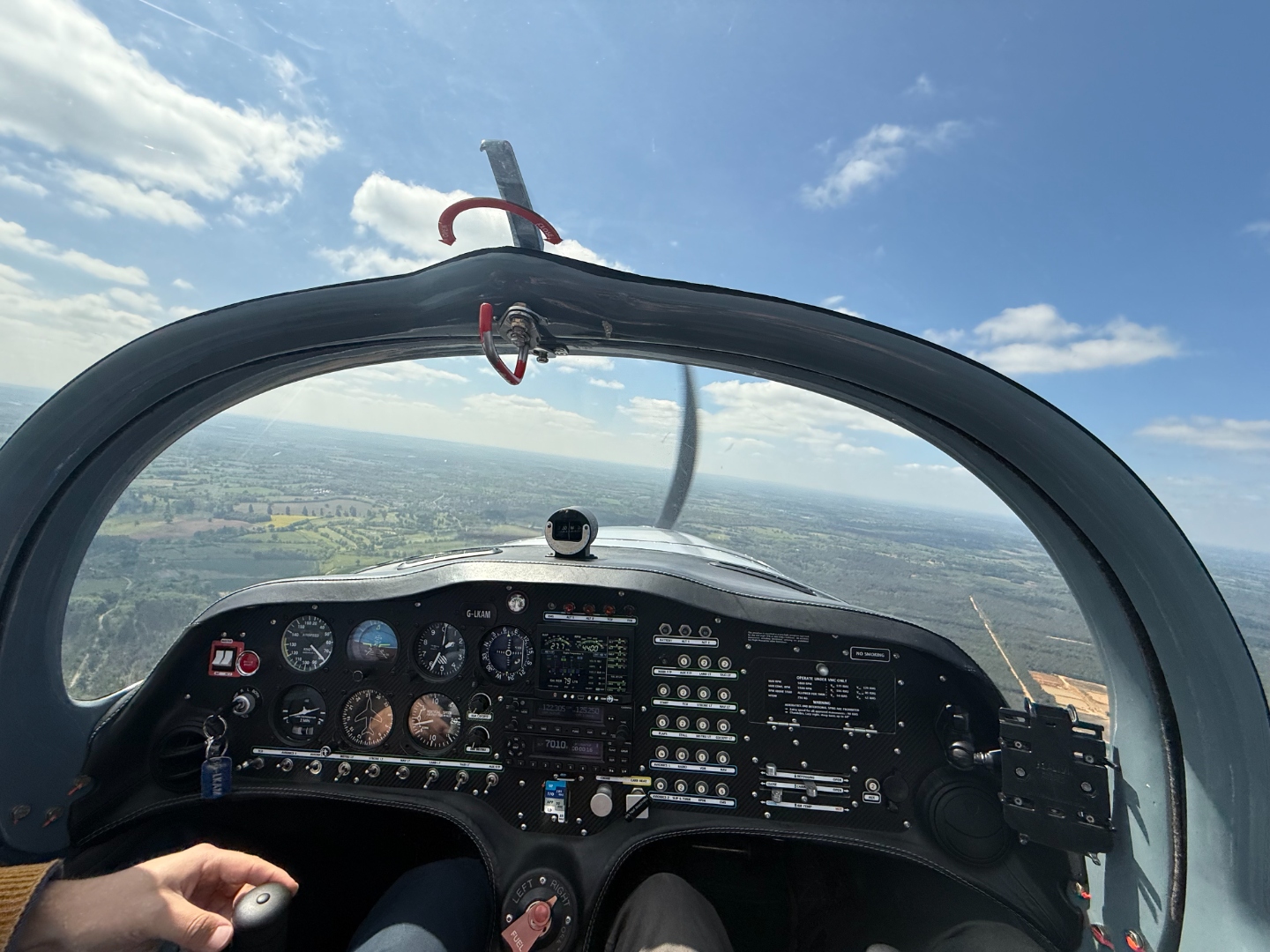 Cockpit view over open countryside during a training flight